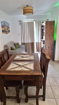 a living room with a wooden table and chairs at GEO departamento in Cordoba
