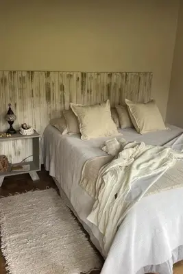 a large bed with white sheets and pillows in a bedroom at Willert hauss in La Cumbrecita