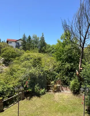 a view of a garden with a house on a hill at Willert hauss in La Cumbrecita