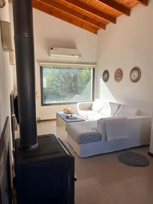 a bedroom with a bed and a stove in a room at Willert hauss in La Cumbrecita