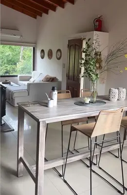 a living room with a wooden table and chairs at Willert hauss in La Cumbrecita
