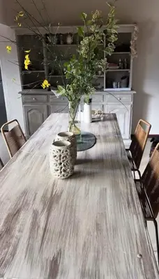 a dining room table with a vase on it at Willert hauss in La Cumbrecita