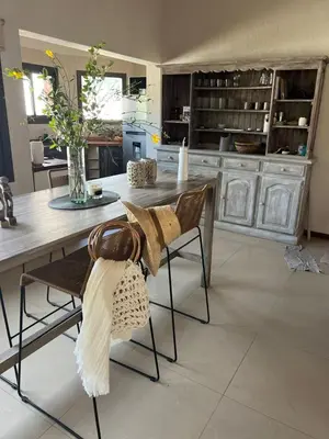 a kitchen with a table and chairs with a counter at Willert hauss in La Cumbrecita