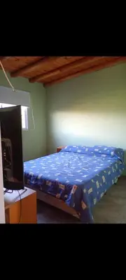a bedroom with a bed and a flat screen tv at El Crespín in San Lorenzo