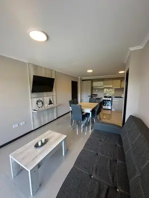 a living room with a couch and a table at Departamento en Veneto Village in Villa Parque Siquiman