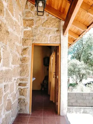 an entrance to a stone building with an open door at Complejo Sol del Valle in Mina Clavero
