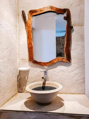 a bathroom with a sink with a mirror on the wall at Complejo Sol del Valle in Mina Clavero