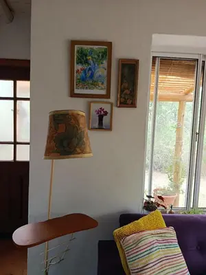 a living room with a purple couch and a lamp at Chañar in Villa de Las Rosas