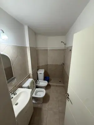 a bathroom with two toilets and a sink at Departamento Olivos IV in Villa Carlos Paz