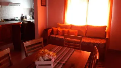 a living room with a table and a couch at Complejo Los Cuatro Elfos in La Estancia