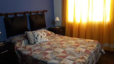 a bedroom with a bed with a quilt on it at Complejo Los Cuatro Elfos in La Estancia