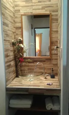 a bathroom with a sink with a mirror and a sink at Complejo Los Cuatro Elfos in La Estancia