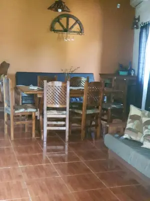 a dining room with a table and chairs at Complejo Los Cuatro Elfos in La Estancia