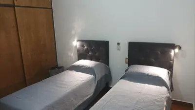 two beds in a small room with twoermottermott at Villa Haus in Villa Carlos Paz
