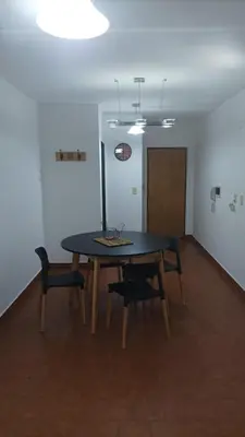 a dining room with a table and two chairs at Villa Haus in Villa Carlos Paz