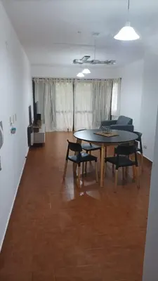 a dining room with a table and chairs in a room at Villa Haus in Villa Carlos Paz