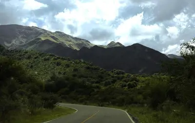 an empty road in front of a mountain range at Casa Merlo San Luis Barrio privado Solares del Valle in Merlo