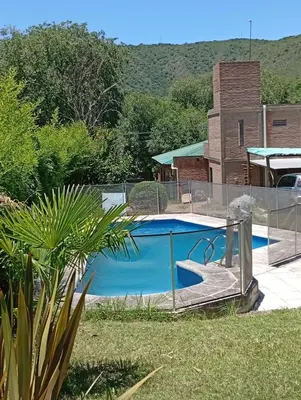 a swimming pool with a fence around it at Posadas La Paz in San Antonio de Arredondo