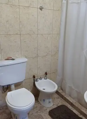 a bathroom with a toilet and a sink and a shower at Posadas La Paz in San Antonio de Arredondo