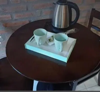 a table with two cups and a tea kettle on it at Posadas La Paz in San Antonio de Arredondo