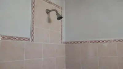 a shower with a shower head in a bathroom at Sierras de Córdoba in Santa María