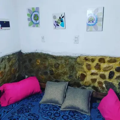 a couch with pink and gray pillows in a room at Abuela Angélica in San Lorenzo