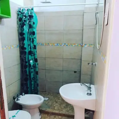 a bathroom with a sink and a toilet at Abuela Angélica in San Lorenzo