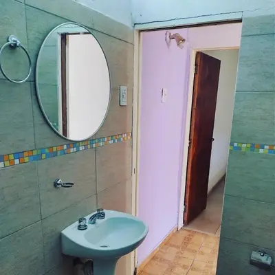 a bathroom with a sink and a mirror at Abuela Angélica in San Lorenzo