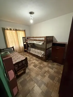 a bedroom with two bunk beds and a dresser at El Algarrobo in Villa del Dique