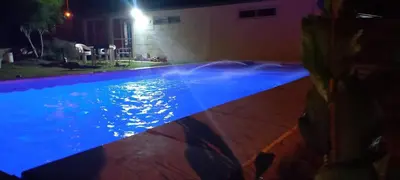 a swimming pool with blue lights in a house at El Algarrobo in Villa del Dique