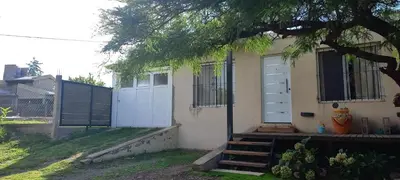 a house with a white door and a fence at El Algarrobo in Villa del Dique