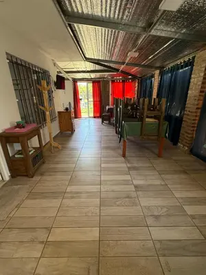 a hallway with a table and chairs in a room at El Algarrobo in Villa del Dique
