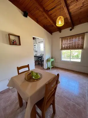 a kitchen and dining room with a table and chairs at Departamento de las sierras in Embalse