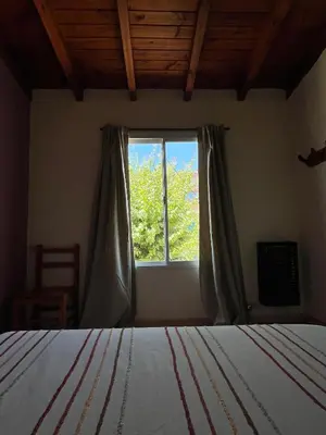 a bedroom with a bed and a window at Departamento de las sierras in Embalse