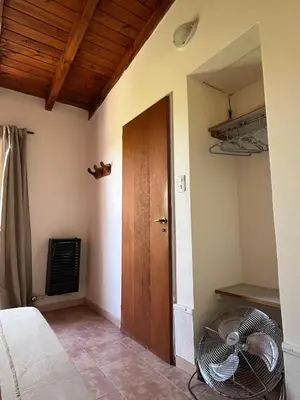 a room with a room with a fan and a door at Departamento de las sierras in Embalse