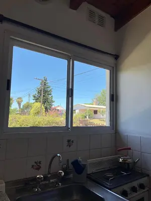 a kitchen with a window over a sink and a sink at Departamento de las sierras in Embalse
