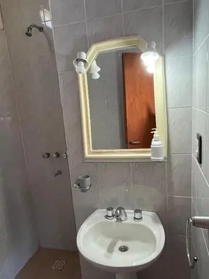 a bathroom with a sink and a mirror at Departamento de las sierras in Embalse