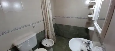 a small bathroom with a sink and a toilet at Cabañas Dionisio in Nono
