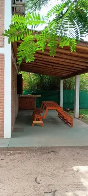 a picnic table and a bench under a pavilion at Cabañas Dionisio in Nono