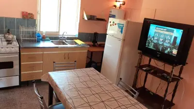 a kitchen with a television on a stand in a kitchen at Cometierra, casa de campo in Panaholma