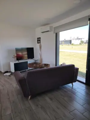 a living room with a couch and a tv at Casa Puerto del Águila Potrero de Garay in La Estancia