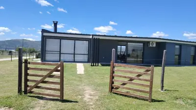 a house with a gate and a fence at Casa Puerto del Águila Potrero de Garay in La Estancia