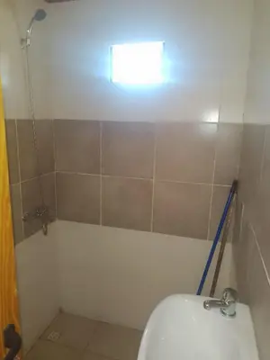 a small bathroom with a toilet and a window at Cabaña Mi Sol in Villa del Dique