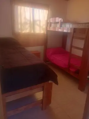a bedroom with two bunk beds and a window at Cabaña Mi Sol in Villa del Dique
