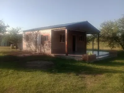 a small brick house with a gambrel roof at Cabaña Mi Sol in Villa del Dique