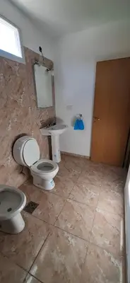 a bathroom with two toilets and a sink at Casa en Traslasierra in Los Hornillos