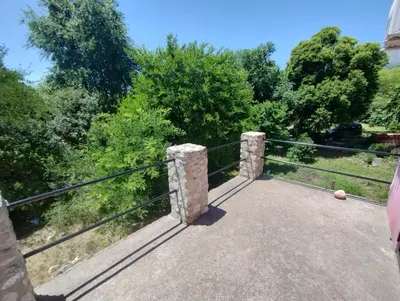 a bridge over a river with trees in the background at Casa en Traslasierra in Los Hornillos