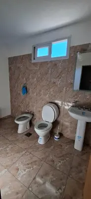 a bathroom with two toilets and a sink at Casa en Traslasierra in Los Hornillos