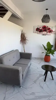 a living room with a couch and a table at Sol del Valle in Mina Clavero