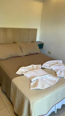 a bed with two towels sitting on top of it at Sol del Valle in Mina Clavero